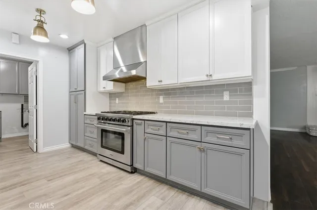 a view of cabinets and utility room with closet dryer