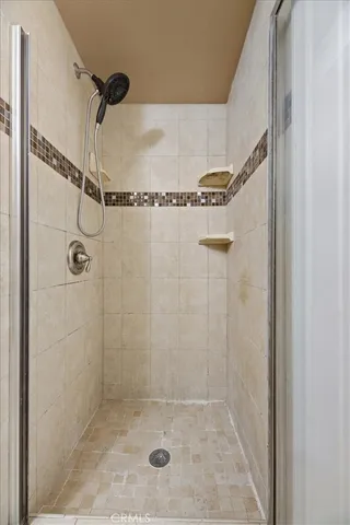 a view of a room with wooden floor ceiling fan and windows