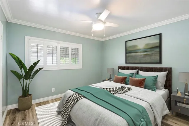 a view of a room with wooden floor and chandelier fan