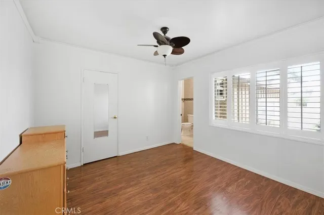 a view of a room with wooden floor and fan