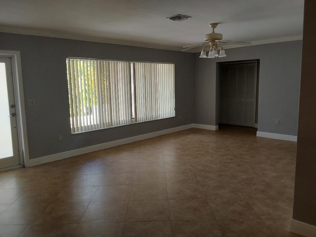 98 Seminole Lane Boca Raton, FL 33487 - Photo 30 of 42 an empty room with wooden floor and windows