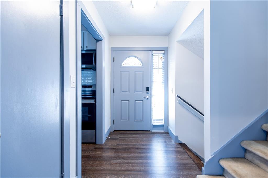 4735 North Springs Road Northwest Kennesaw, GA 30144 - Photo 12 of 34 a view of a hallway with wooden floor and staircase