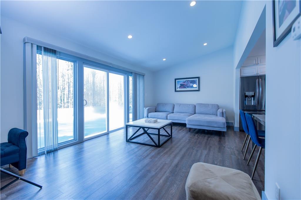 4735 North Springs Road Northwest Kennesaw, GA 30144 - Photo 13 of 34 a living room with furniture and wooden floor