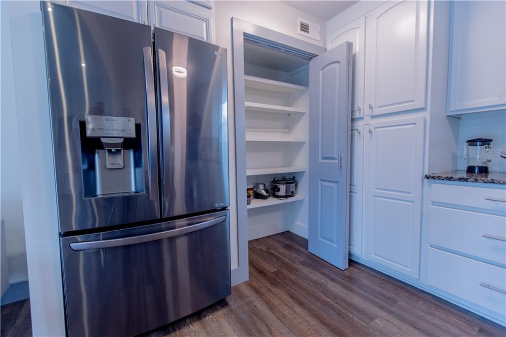 4735 North Springs Road Northwest Kennesaw, GA 30144 - Photo 18 of 34 a kitchen with a refrigerator and cabinets