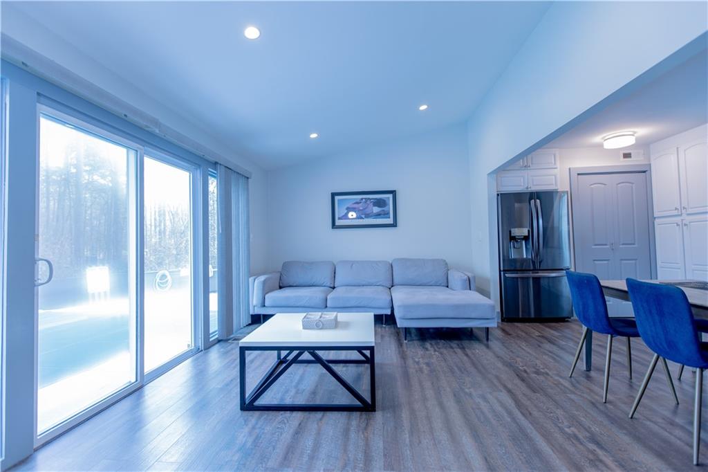 4735 North Springs Road Northwest Kennesaw, GA 30144 - Photo 26 of 34 a living room with furniture and wooden floor