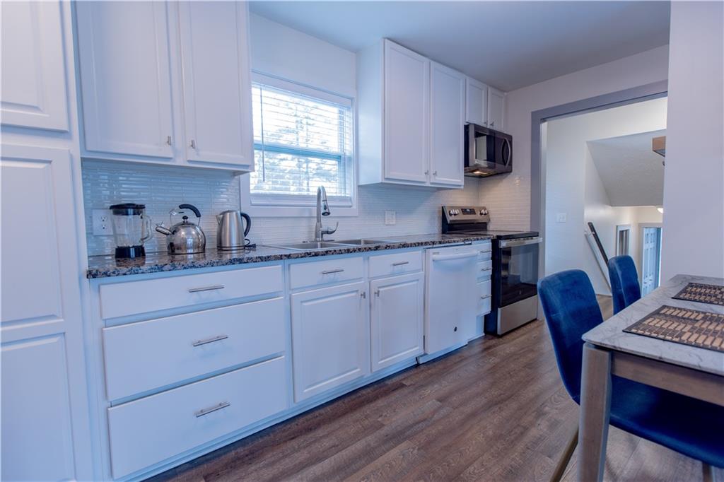 4735 North Springs Road Northwest Kennesaw, GA 30144 - Photo 27 of 34 a kitchen with sink cabinets and wooden floor