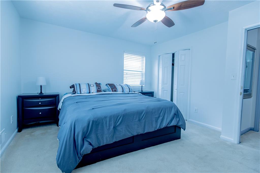 4735 North Springs Road Northwest Kennesaw, GA 30144 - Photo 31 of 34 a spacious bedroom with a bed and a chandelier