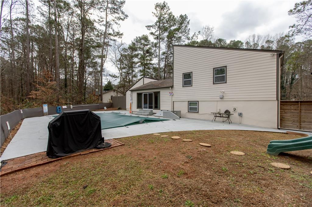 4735 North Springs Road Northwest Kennesaw, GA 30144 - Photo 34 of 34 a view of a house with backyard and sitting area