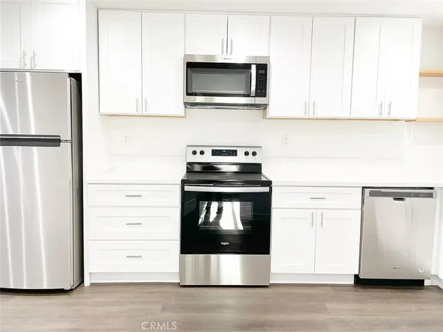a kitchen with a stove and a microwave
