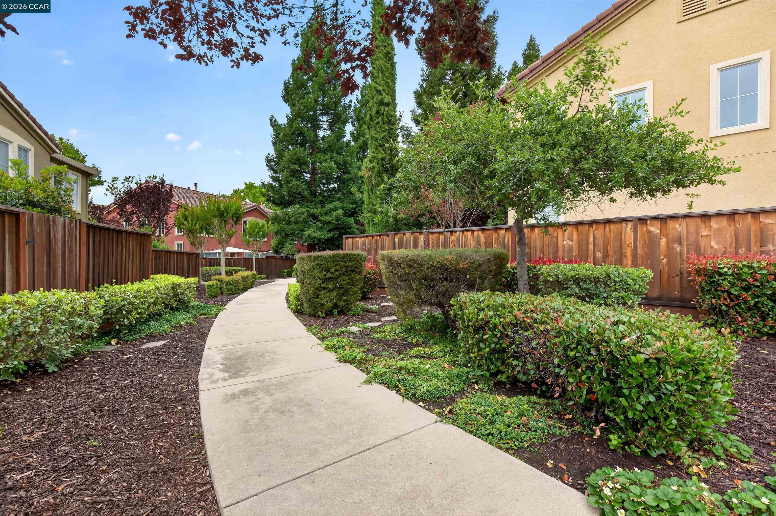 124 Coralflower Lane San Ramon, CA 94582 - Photo 32 of 47 a view of a backyard with potted plants and wooden fence