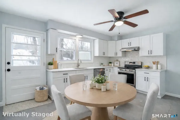 a kitchen with a sink cabinets and window