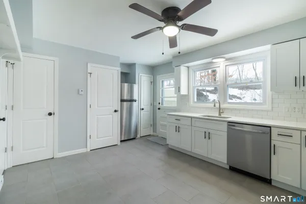 a large bathroom with a large tub and sink