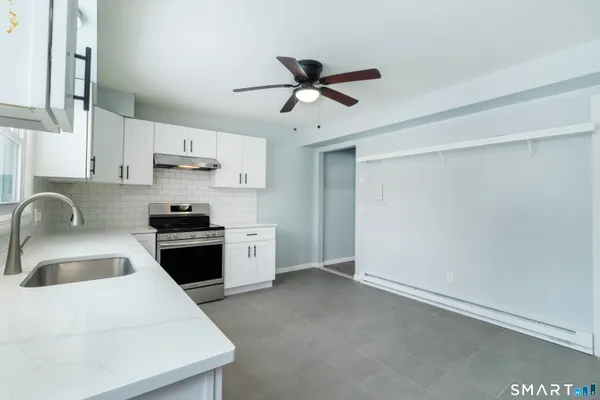 a kitchen with stainless steel appliances a sink stove and refrigerator