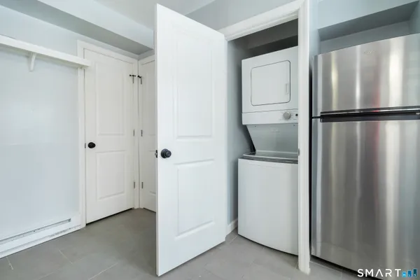 a room with a refrigerator and mirror
