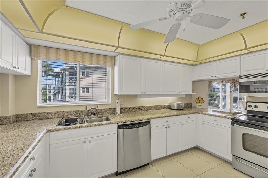 11000 Placida Road, Unit 1801 Placida, FL 33946 - Photo 13 of 53 a kitchen with stainless steel appliances granite countertop a sink and cabinets