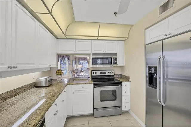 a kitchen with a sink cabinets and stainless steel appliances