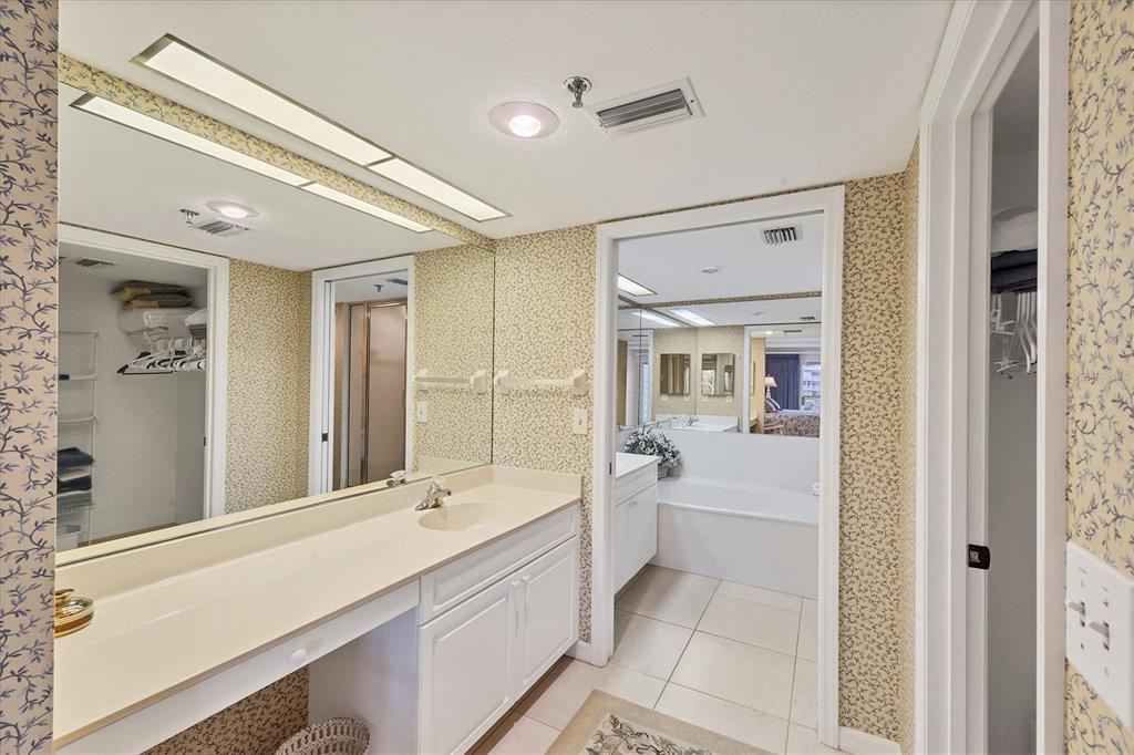 11000 Placida Road, Unit 1801 Placida, FL 33946 - Photo 20 of 53 a bathroom with a tub a sink and mirror