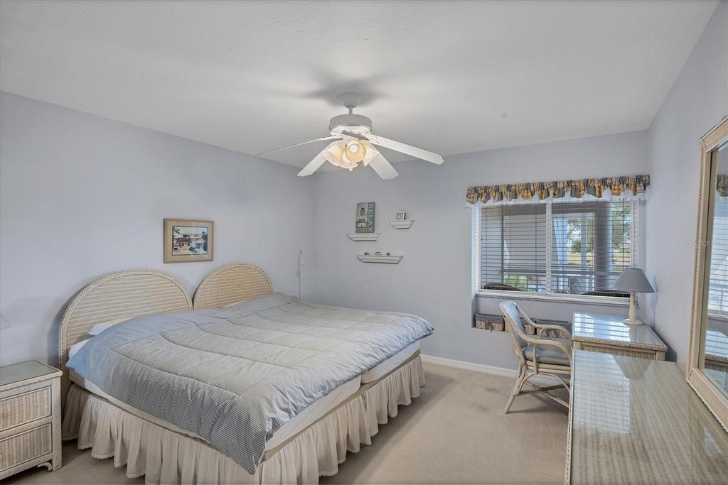 11000 Placida Road, Unit 1801 Placida, FL 33946 - Photo 22 of 53 a bedroom with a bed and a chandelier