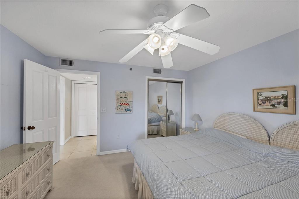 11000 Placida Road, Unit 1801 Placida, FL 33946 - Photo 23 of 53 a bedroom with a large bed and a chandelier