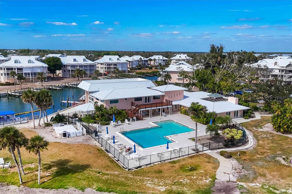 11000 Placida Road, Unit 1801 Placida, FL 33946 - Photo 28 of 53 an aerial view of a house with a swimming pool outdoor seating and yard