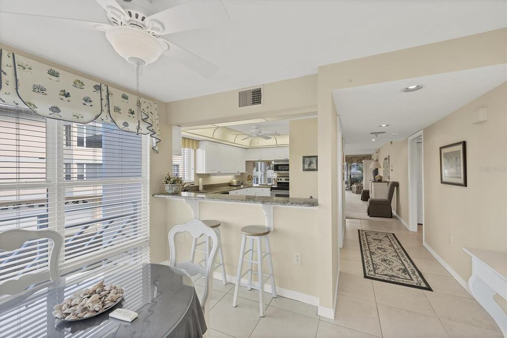 11000 Placida Road, Unit 1801 Placida, FL 33946 - Photo 4 of 53 a kitchen with stainless steel appliances kitchen island granite countertop a sink and cabinets