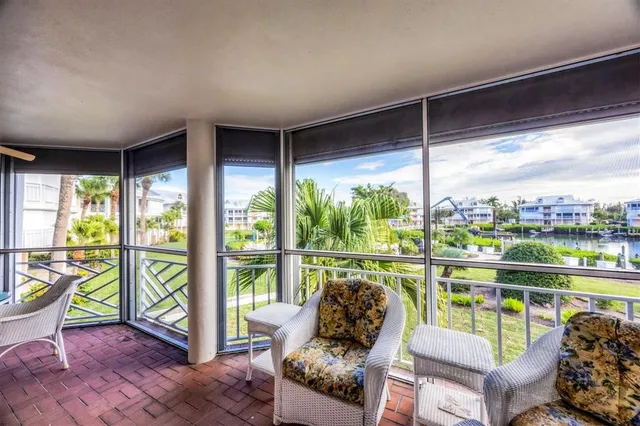 a living room with furniture and floor to ceiling windows