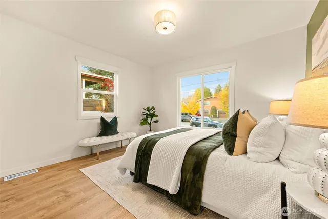 a spacious bedroom with a bed and a window