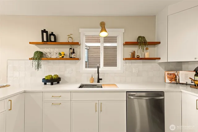a kitchen with a sink a stove and cabinets