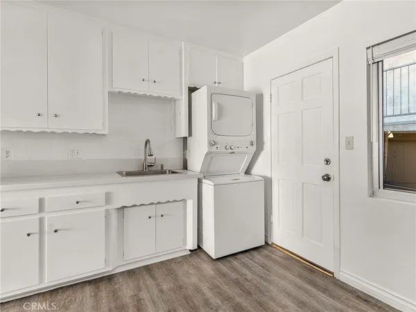 a kitchen with white cabinets and white appliances