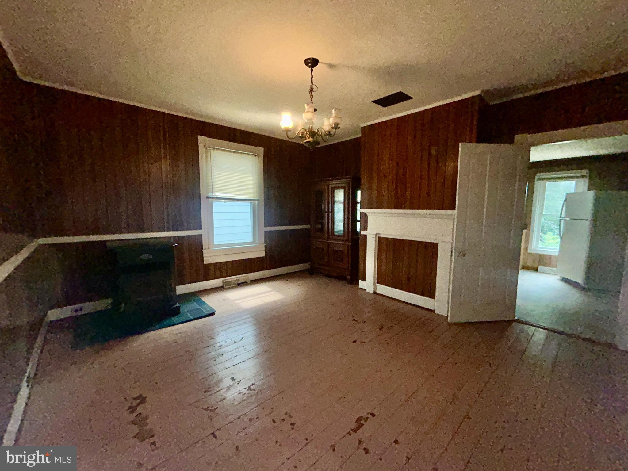 161 East Main Street Orange, VA 22960 - Photo 14 of 37 a view of a livingroom with wooden floor a fireplace and window