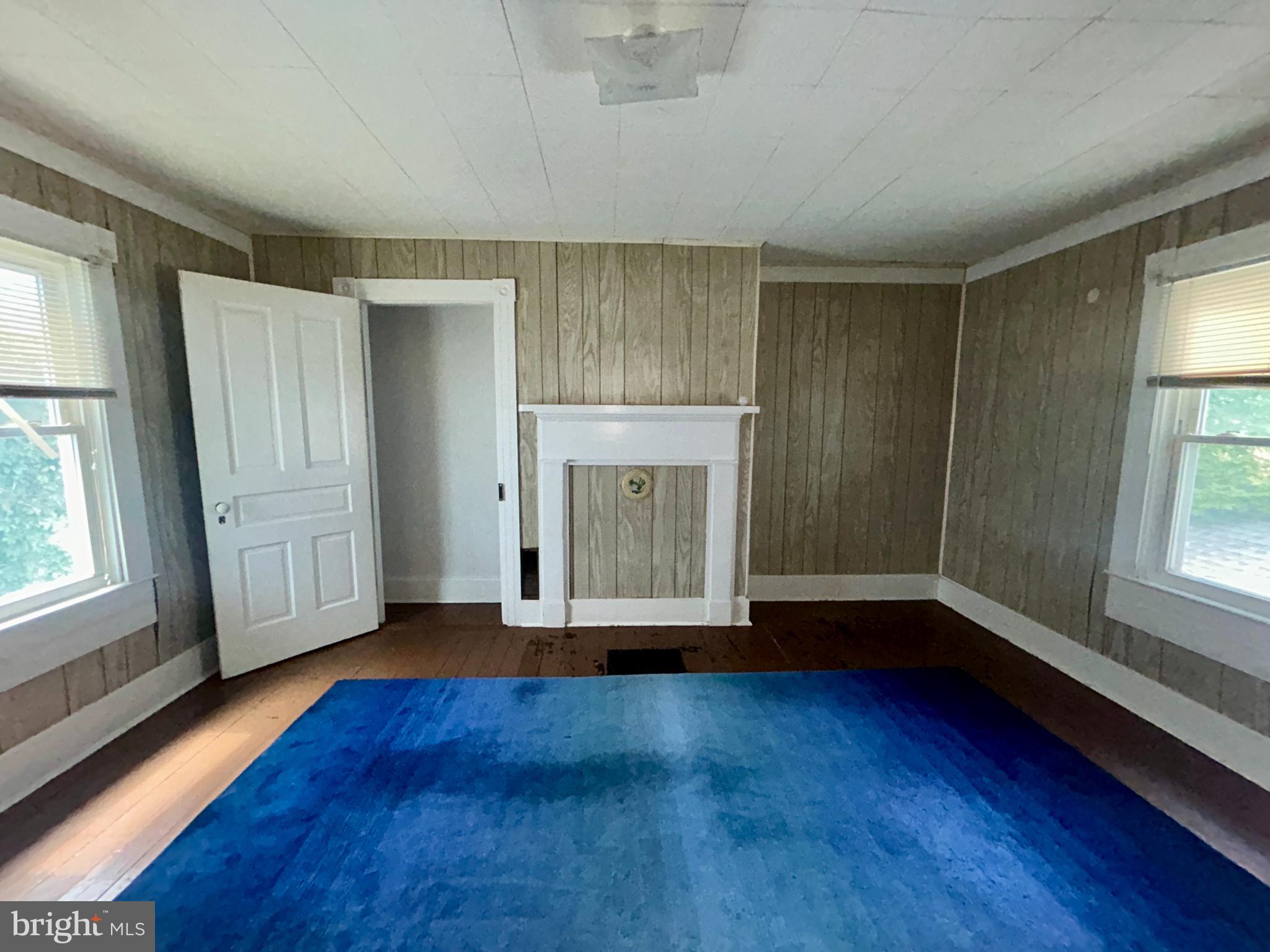 161 East Main Street Orange, VA 22960 - Photo 19 of 37 an empty room with wooden floor and windows