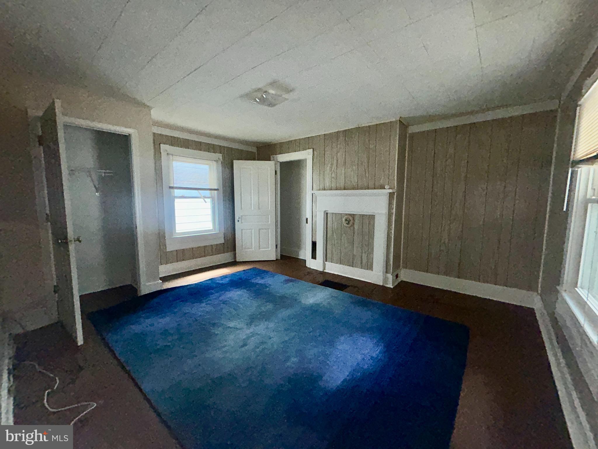 161 East Main Street Orange, VA 22960 - Photo 20 of 37 an empty room with wooden floor and windows