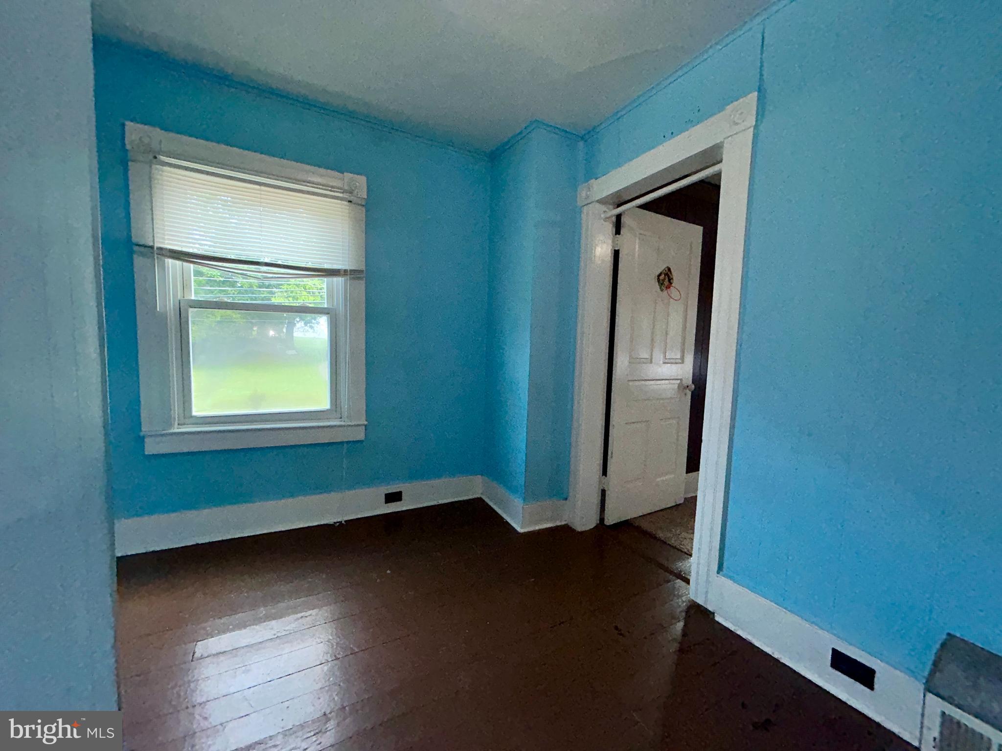 161 East Main Street Orange, VA 22960 - Photo 23 of 37 an empty room with wooden floor cabinet and windows