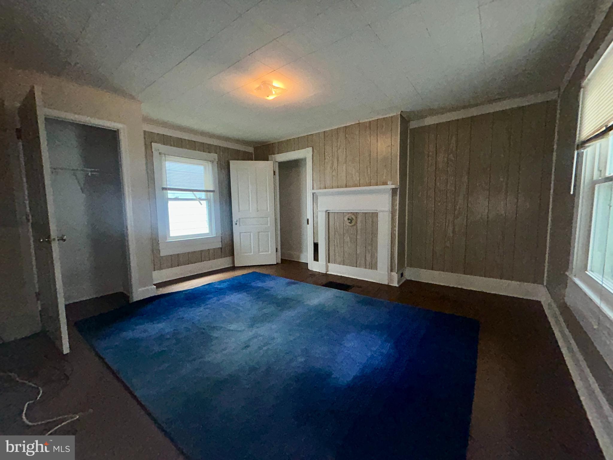161 East Main Street Orange, VA 22960 - Photo 26 of 37 an empty room with wooden floor and windows