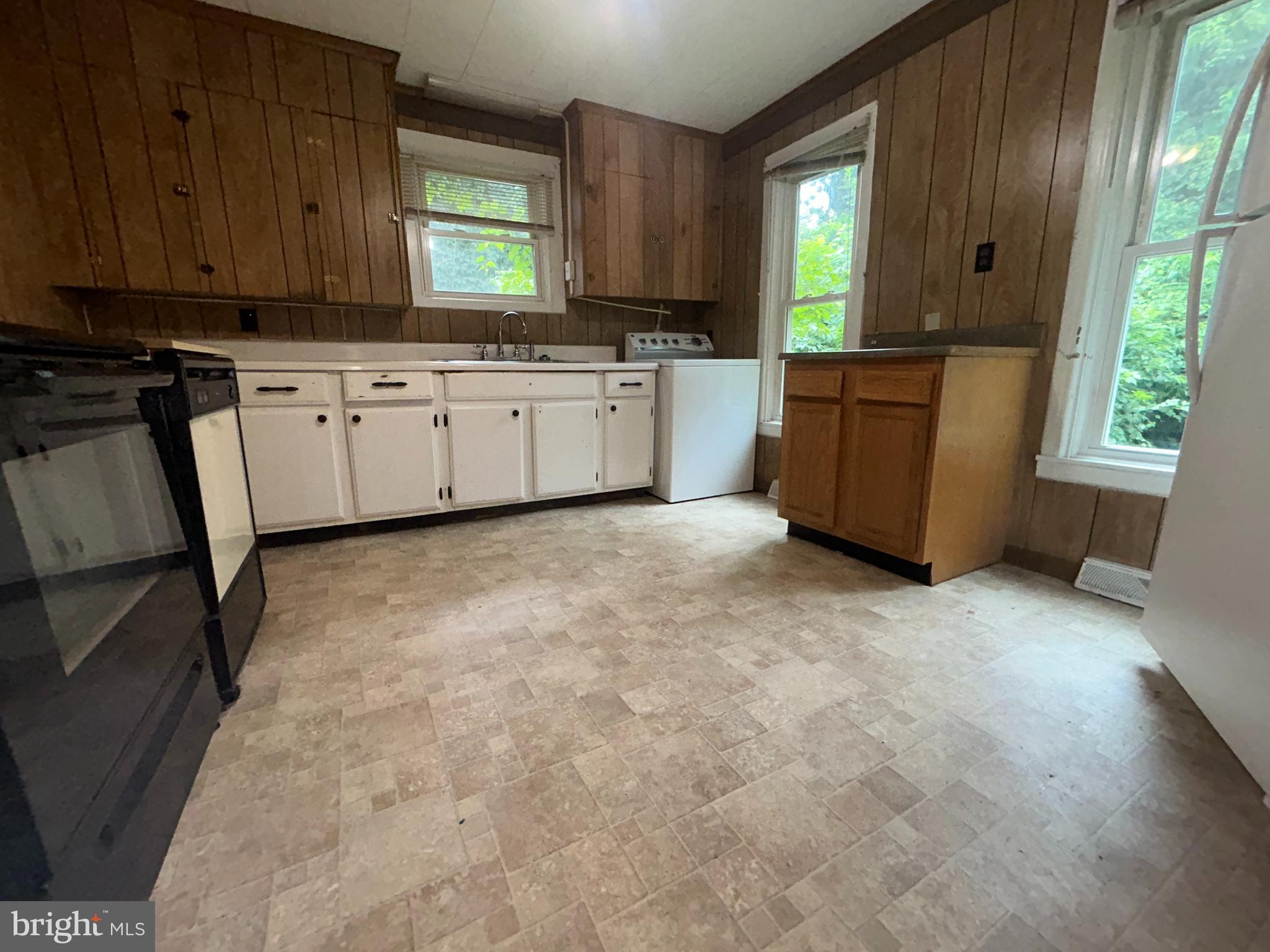 161 East Main Street Orange, VA 22960 - Photo 4 of 37 a kitchen with granite countertop a sink window and cabinets