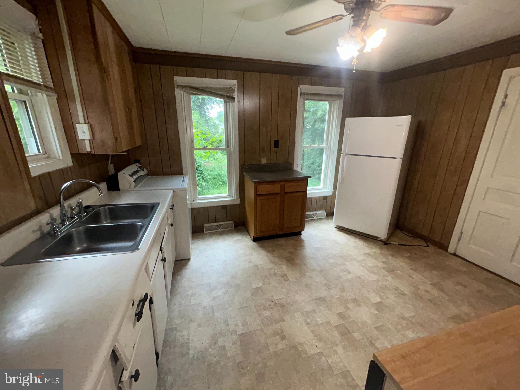 161 East Main Street Orange, VA 22960 - Photo 5 of 37 a kitchen with a refrigerator and a sink