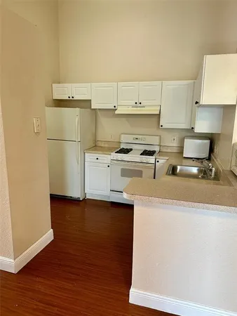 a utility room with cabinets washer and dryer