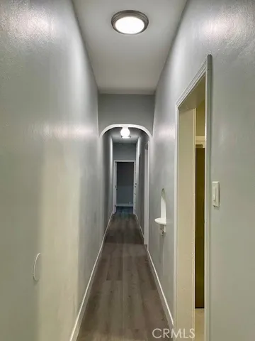 a view of an empty room with a fireplace and a window