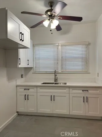 a kitchen with cabinets stainless steel appliances and a sink
