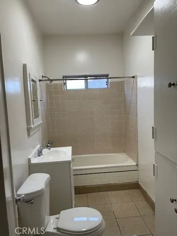 a bathroom with a toilet a sink and bathtub