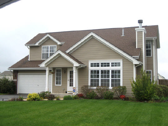 738 Bayfield Road Rockton, IL 61072 - Photo 1 of 10 a front view of a house with a large garden and plants
