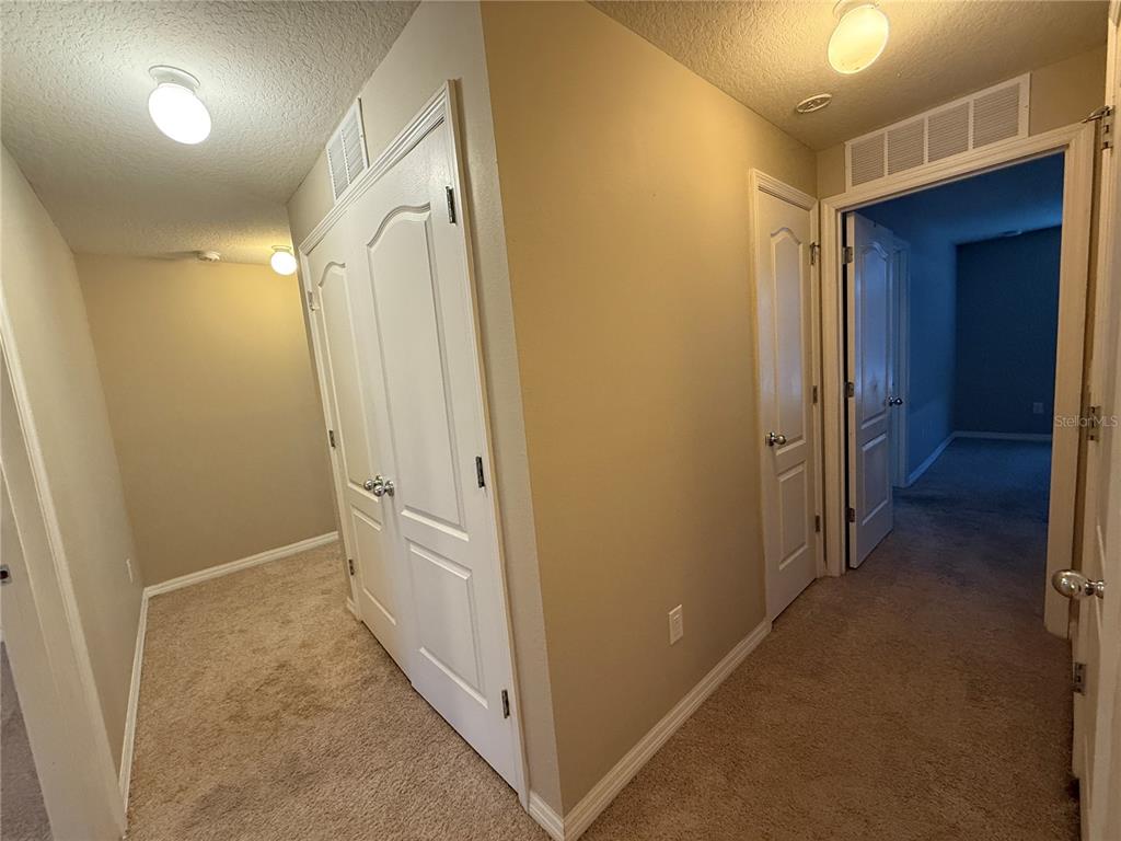 1623 Reflection Cove St. Cloud, FL 34771 - Photo 14 of 33 a view of a hallway with closet and wooden floor