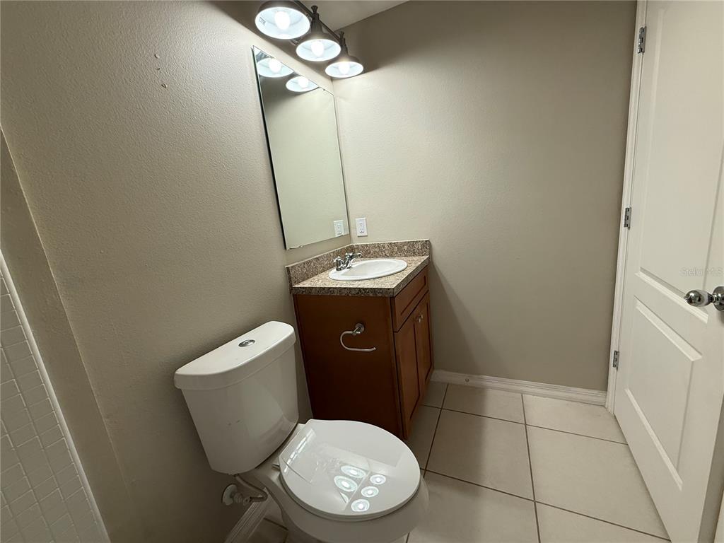 1623 Reflection Cove St. Cloud, FL 34771 - Photo 22 of 33 a bathroom with a toilet and a mirror