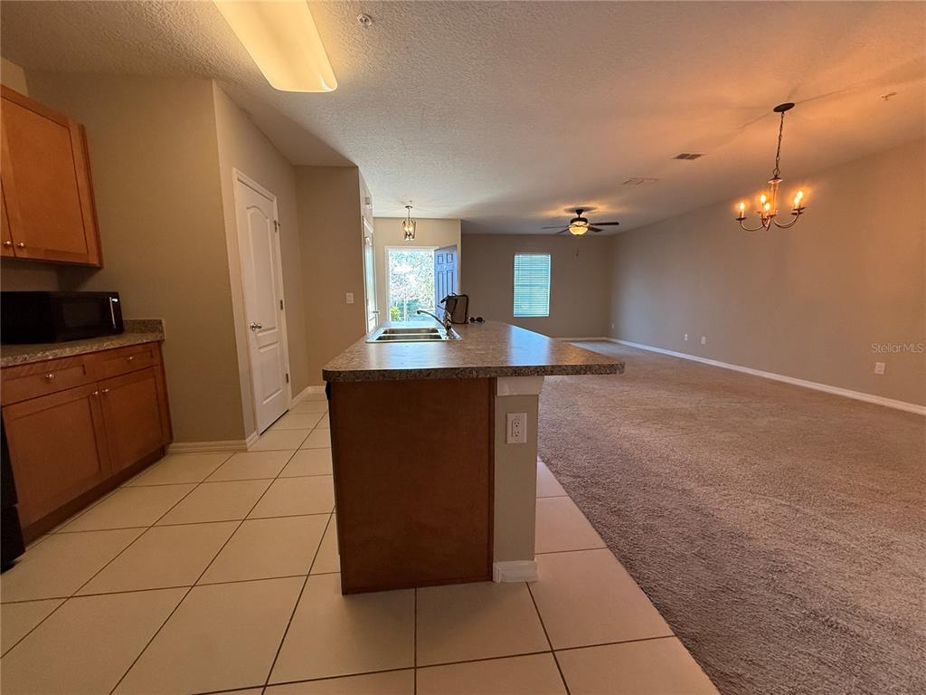 1623 Reflection Cove St. Cloud, FL 34771 - Photo 10 of 33 a kitchen with kitchen island cabinets and window