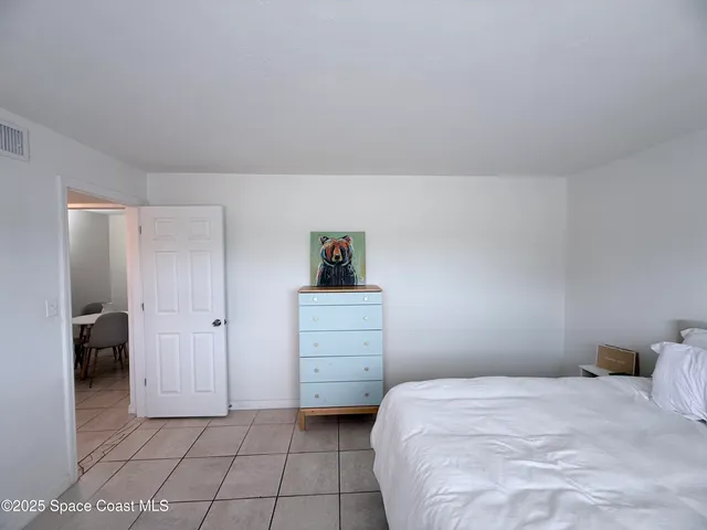 a bathroom with a granite countertop sink a toilet a mirror and bathtub