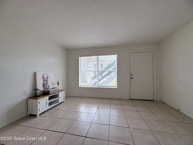 a dining room with furniture and a kitchen view