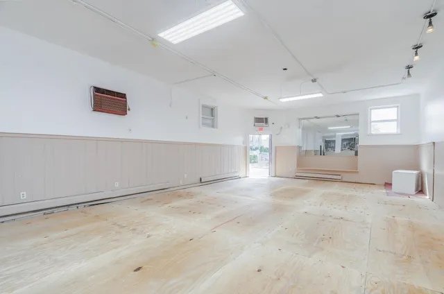 a big room with chandelier and windows