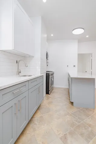 a kitchen with a sink and cabinets