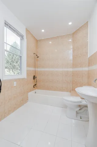 a bathroom with a bathtub and a toilet