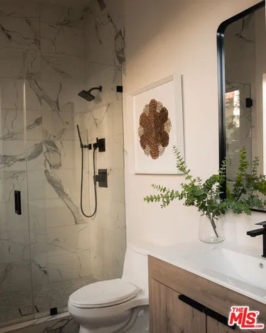 a living room with fireplace furniture and a large window